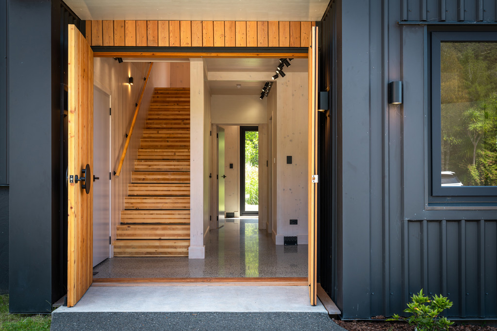 Entry pivot door with Italian mountain spruce timber staircase