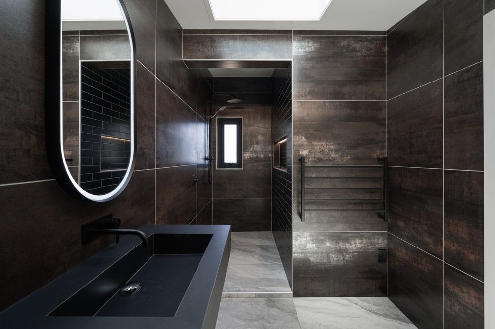 Master ensuite with dark oxide tiles and premium finishes